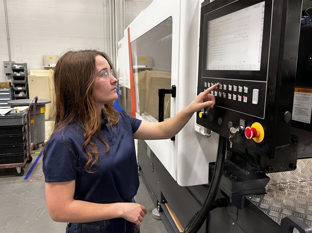 team member operating an injection molding machine that makes PVC fittings
